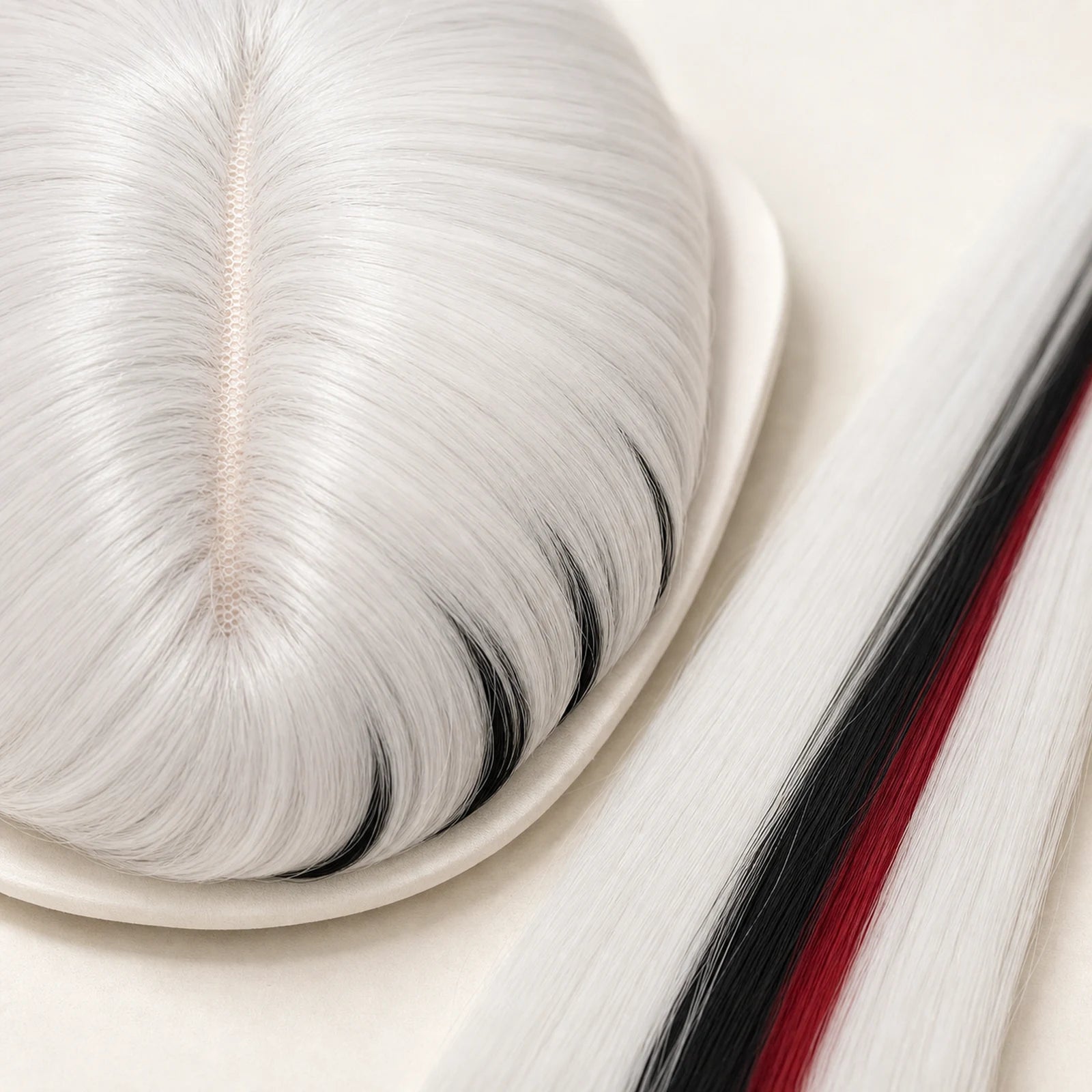 Close-up of CosNova white black red heat-resistant synthetic wig fiber and crown parting