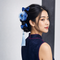 CosNova gradient blue flower bow and tassel hair clip set worn in a braided updo