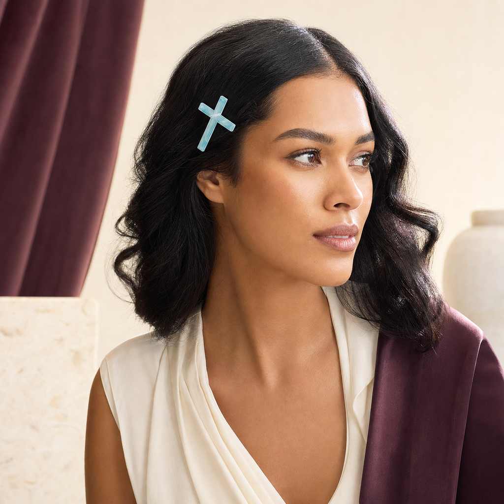 CosNova light cyan translucent cross hair clip worn in an adult model's side hairstyle