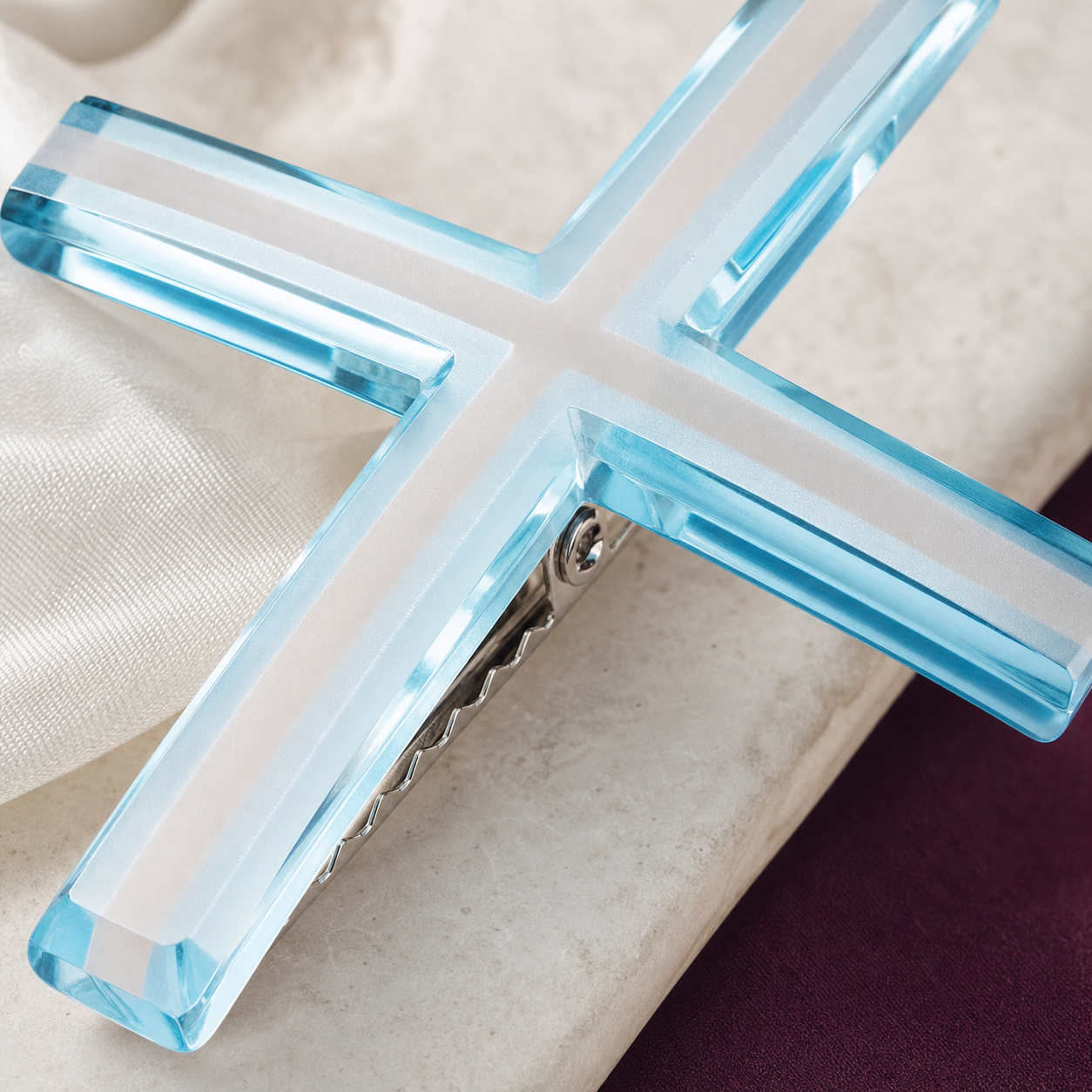 Macro detail of CosNova translucent cyan resin white cross inset and polished beveled edge
