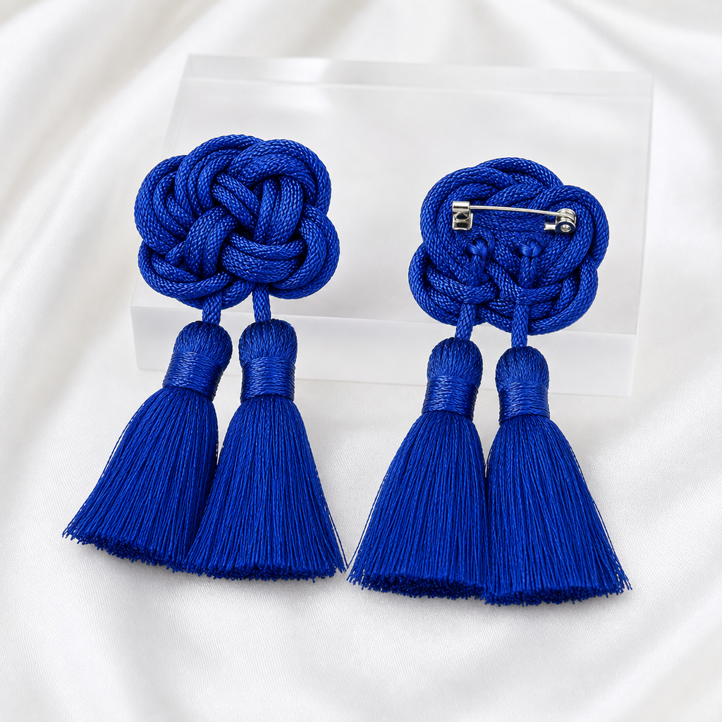 CosNova royal blue knotted tassel brooch pair showing front view and hidden silver-tone pin backing