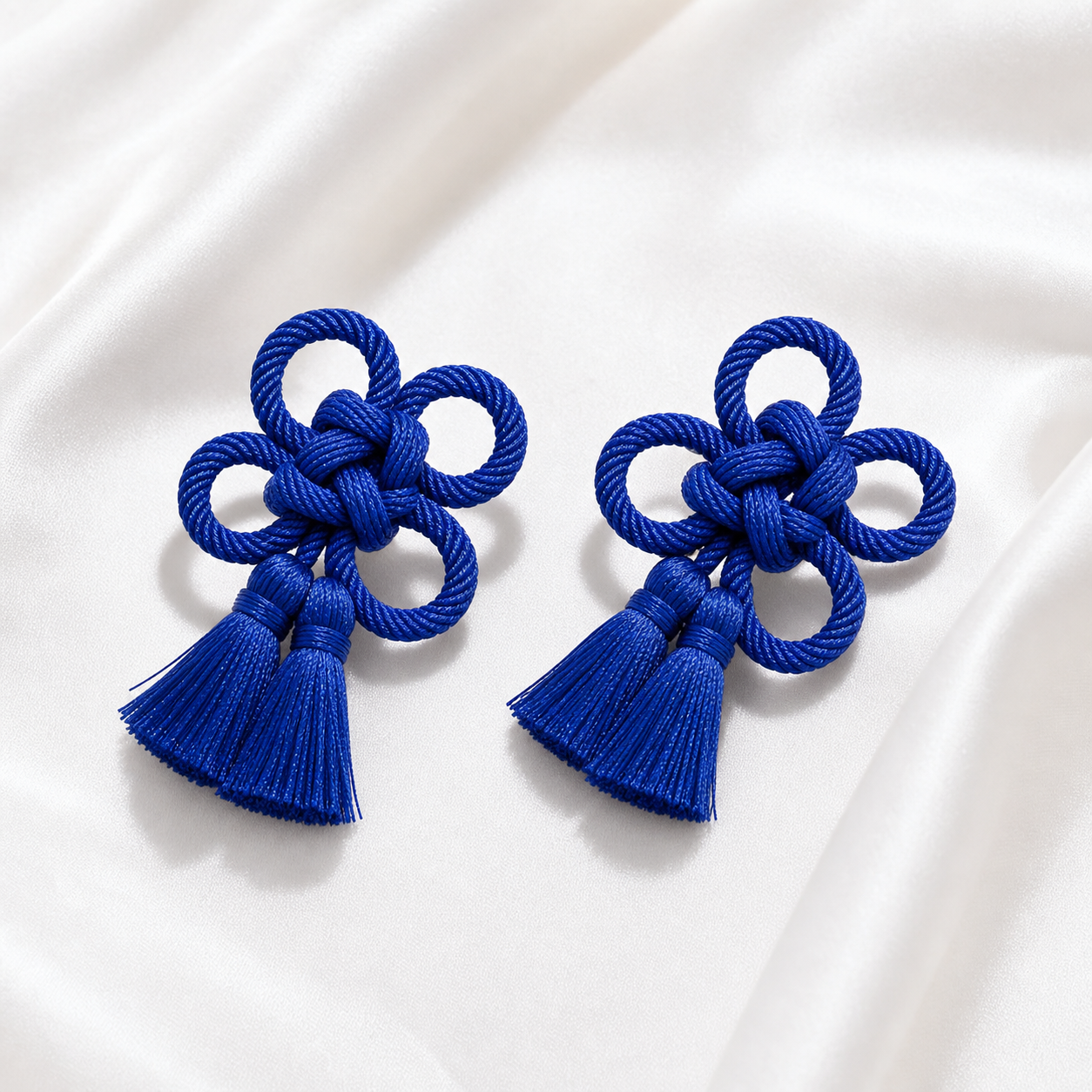 CosNova royal blue knotted tassel brooch pair on white satin with braided cord knots and short tassels