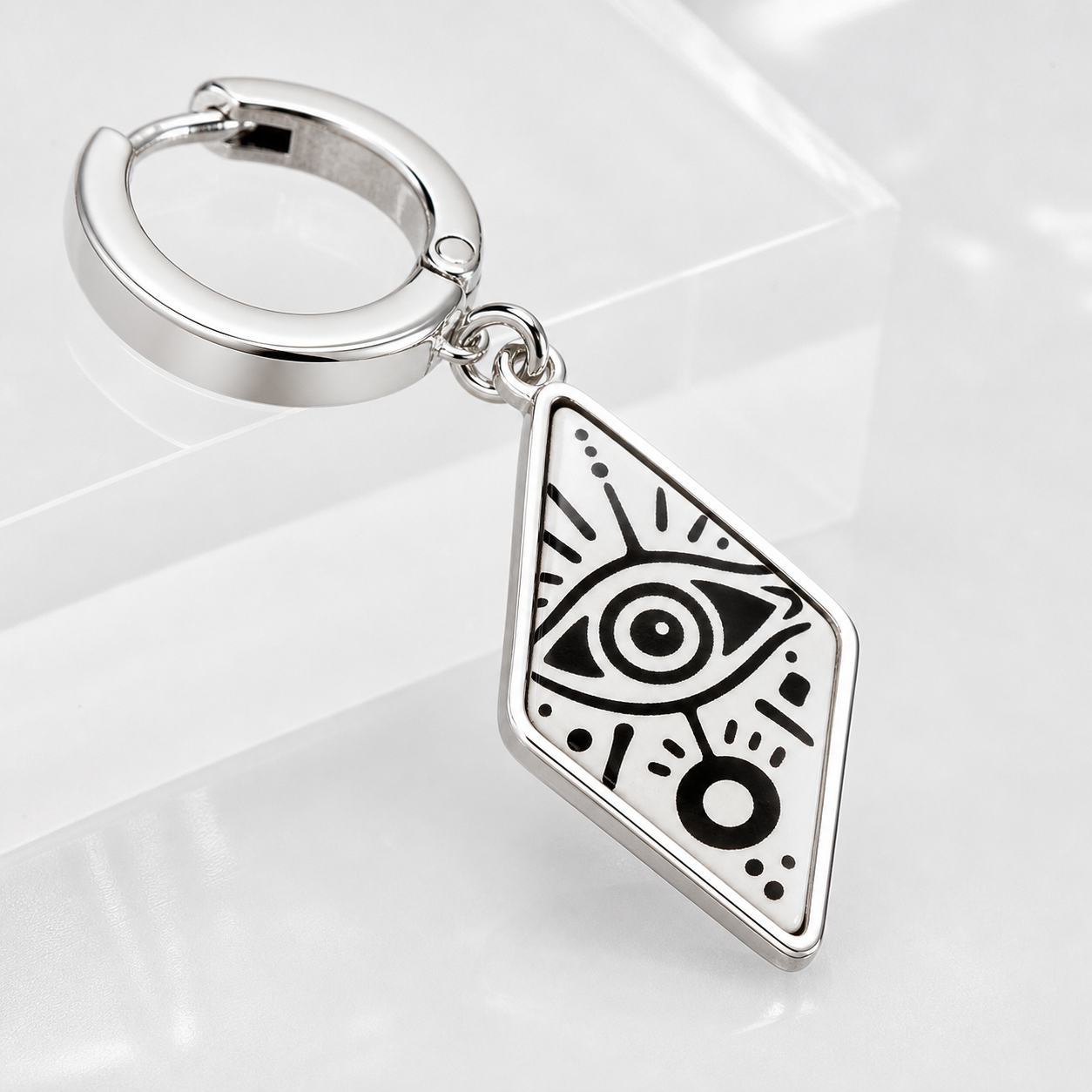 Macro detail of CosNova silver hoop clasp and diamond eye print acrylic charm