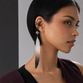 CosNova long white-to-black gradient feather ear cuff worn by a model with short black hair