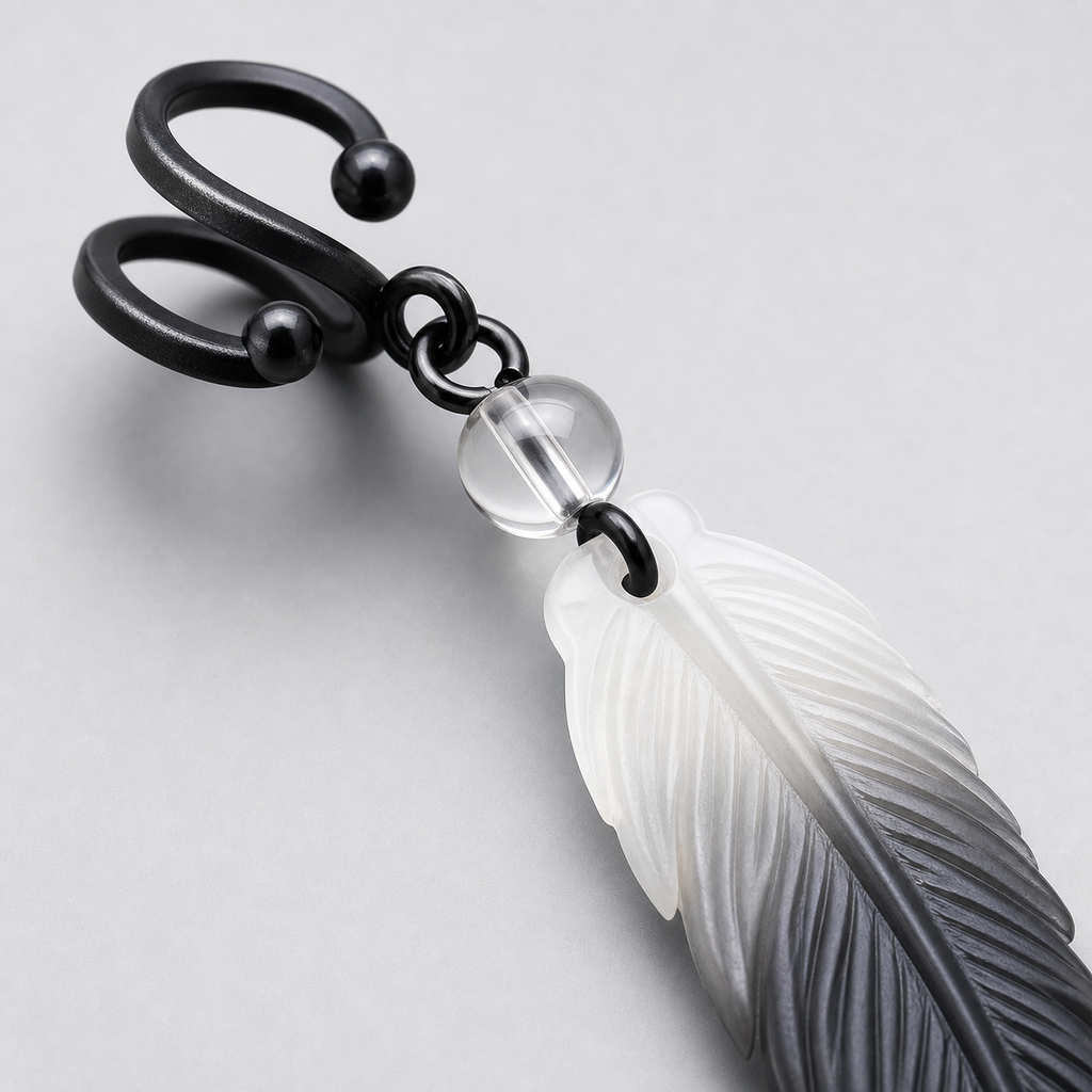 Macro detail of CosNova black adjustable ear cuff clear bead connector and engraved gradient resin feather